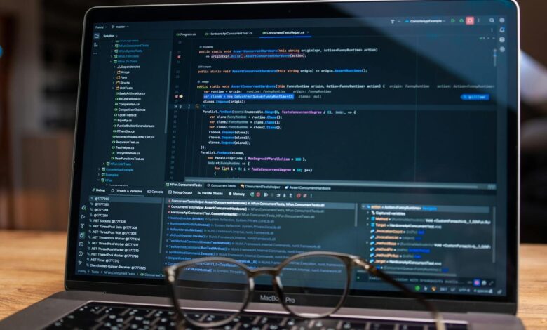 Laptop screen showing debugging software with code, perfect for tech and software development themes.